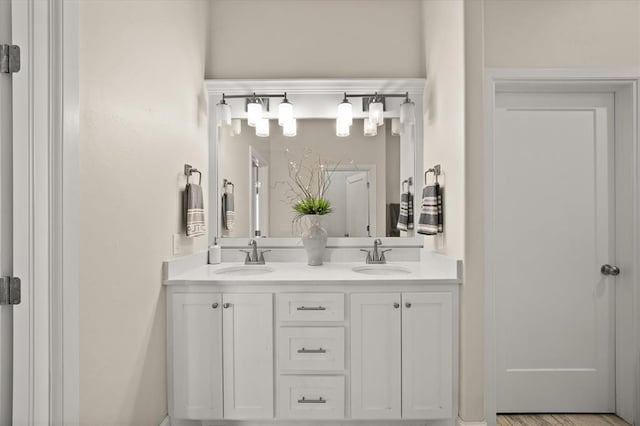 bathroom featuring a sink and double vanity