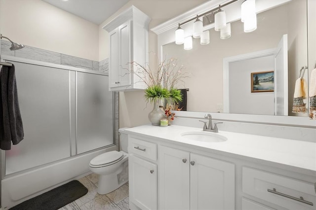 bathroom featuring enclosed tub / shower combo, toilet, and vanity