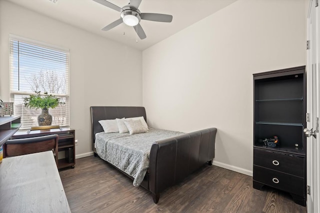 bedroom featuring a ceiling fan, baseboards, and dark wood-style flooring