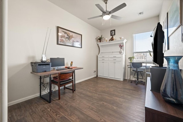 office with dark wood-type flooring, visible vents, baseboards, and a ceiling fan