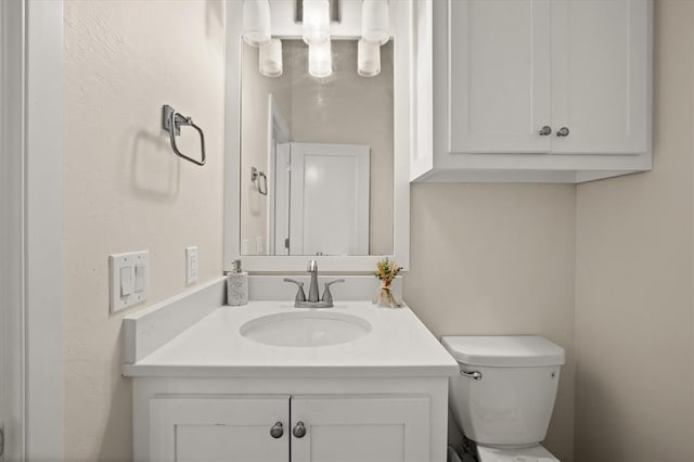 half bath featuring toilet and vanity