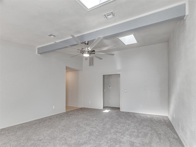 empty room featuring visible vents, beamed ceiling, carpet, and a ceiling fan