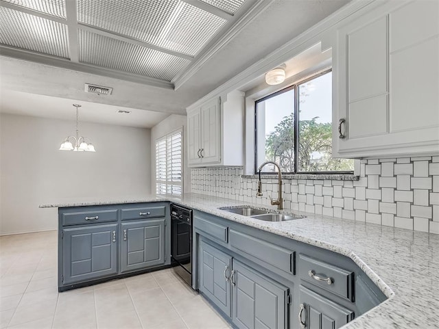 kitchen featuring a peninsula, a sink, visible vents, white cabinets, and black dishwasher