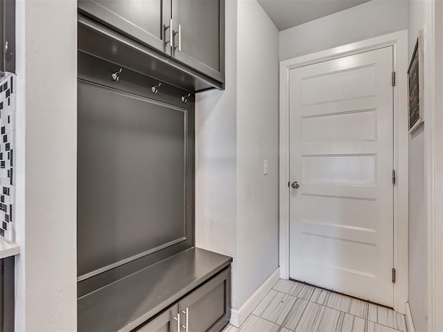 mudroom featuring light tile patterned flooring and baseboards