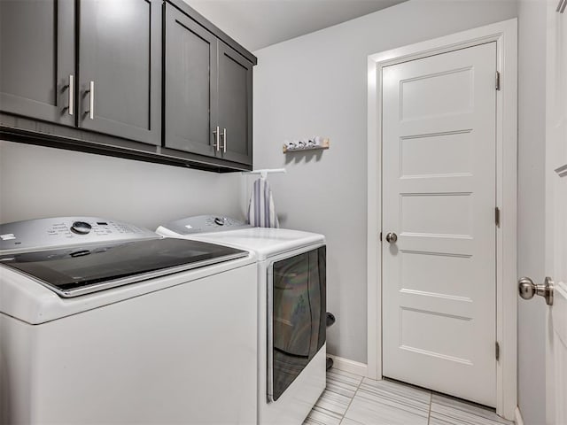 laundry area featuring cabinet space, independent washer and dryer, and baseboards