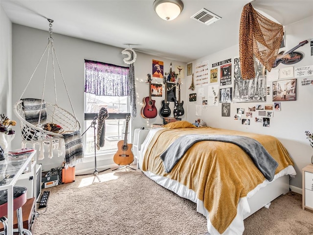 bedroom with carpet floors, baseboards, and visible vents