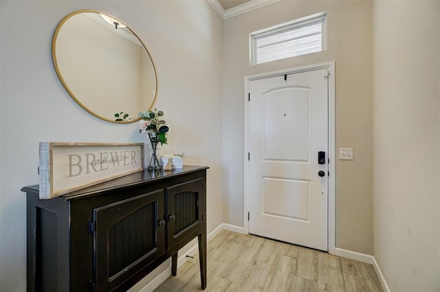 entryway with ornamental molding, light wood finished floors, and baseboards