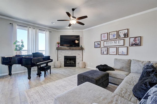 living room with baseboards, visible vents, crown molding, and wood finished floors