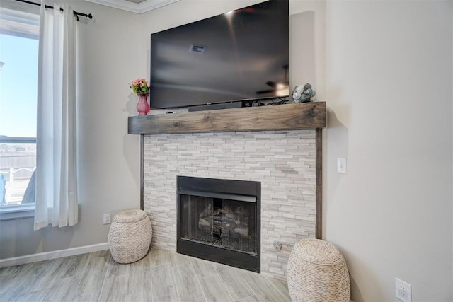 details with a fireplace, baseboards, and wood finished floors