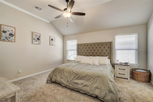 bedroom featuring carpet, visible vents, lofted ceiling, and multiple windows