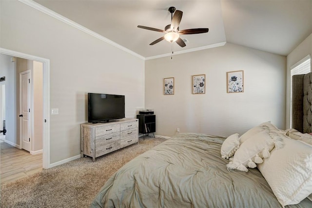 bedroom featuring baseboards, a ceiling fan, light colored carpet, lofted ceiling, and crown molding