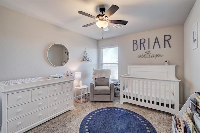 carpeted bedroom with a nursery area, visible vents, and ceiling fan