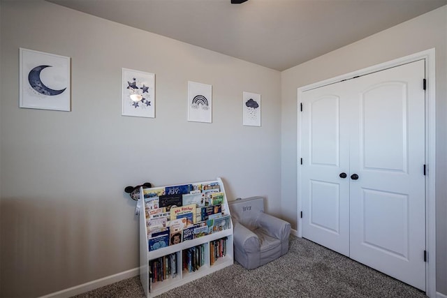 recreation room with baseboards and carpet flooring