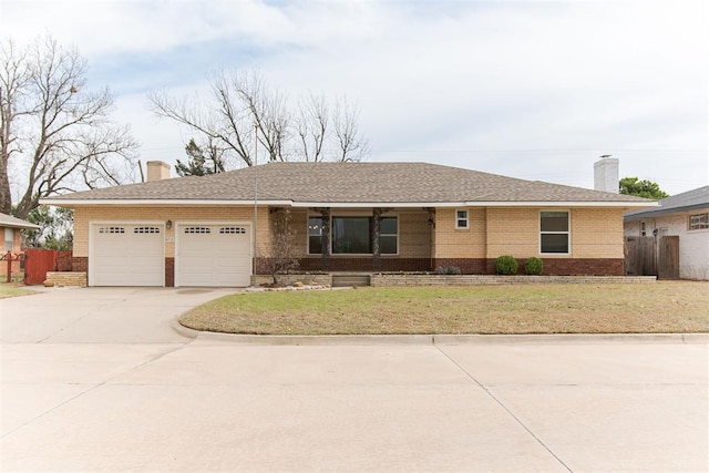 ranch-style house with brick siding, concrete driveway, a chimney, and fence