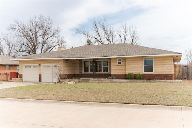 ranch-style home featuring brick siding, fence, a front yard, a garage, and driveway