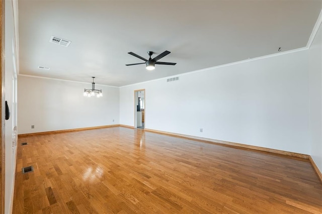 spare room with visible vents, light wood-style flooring, and crown molding