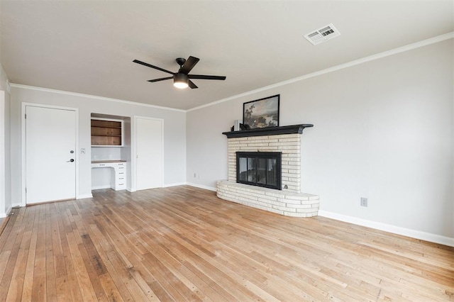 unfurnished living room featuring a ceiling fan, visible vents, baseboards, a fireplace, and wood-type flooring