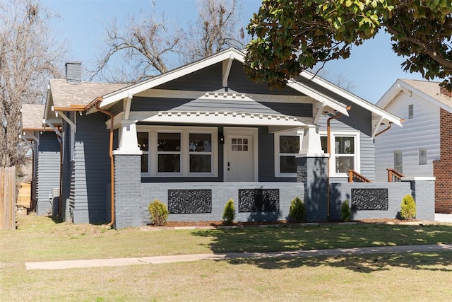 view of front of house with a front yard and a chimney