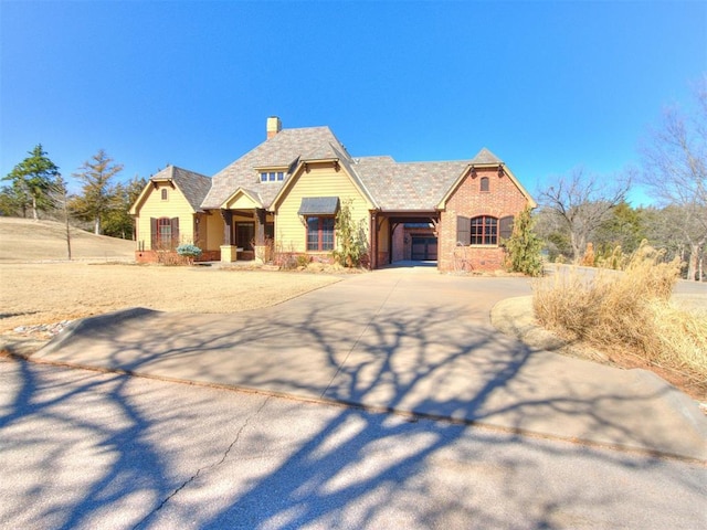 view of front of home with driveway and a chimney