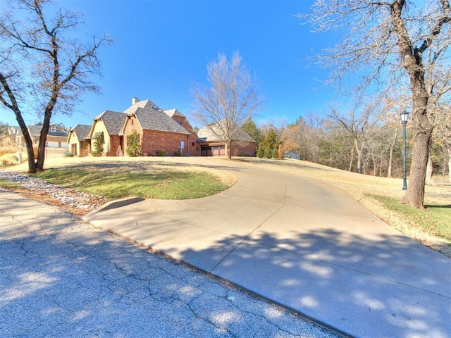 exterior space featuring driveway and a front lawn