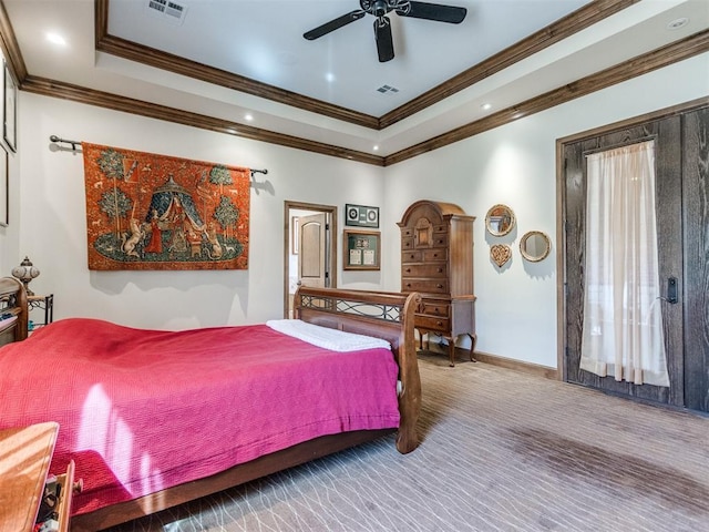 bedroom featuring ornamental molding, a raised ceiling, visible vents, and baseboards