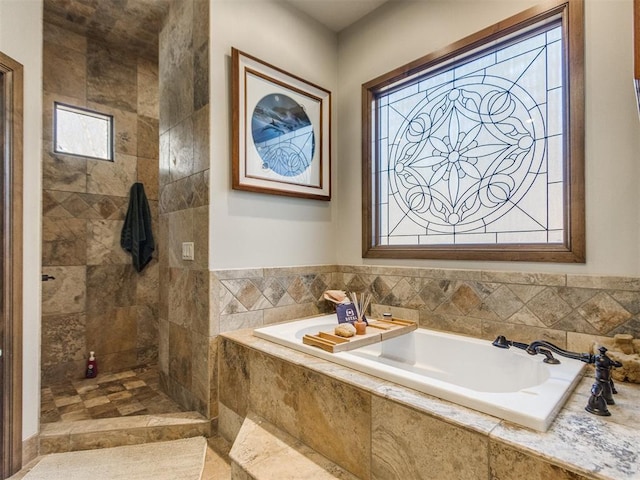 bathroom featuring tiled shower and a bath