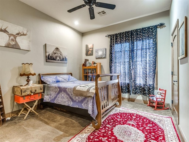 bedroom with baseboards, carpet floors, visible vents, and a ceiling fan