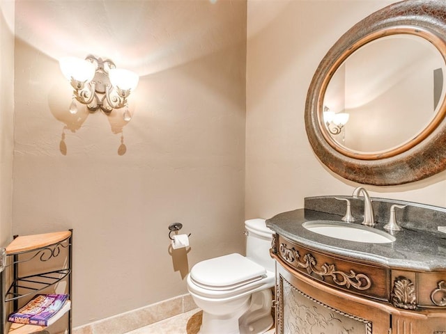 half bathroom with toilet, tile patterned floors, a chandelier, and vanity