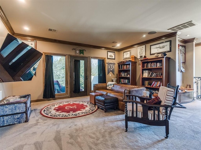 living area with carpet flooring, visible vents, and crown molding