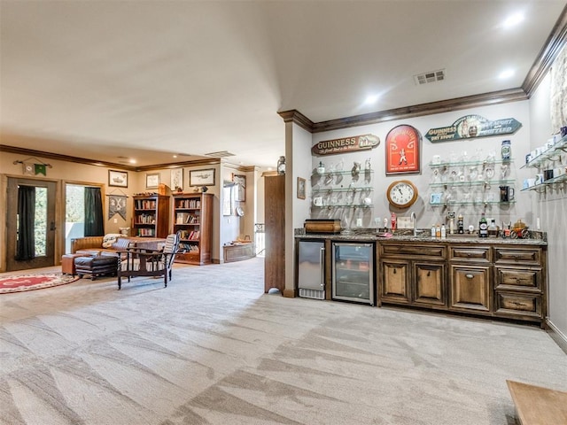 bar with wine cooler, light colored carpet, visible vents, a dry bar, and crown molding