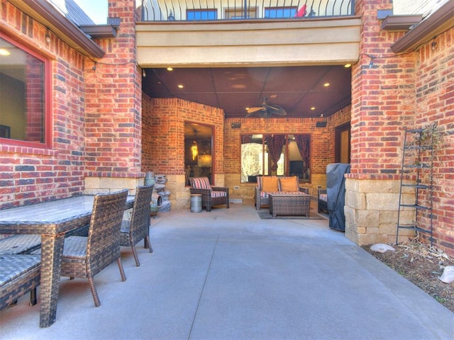 view of patio / terrace with ceiling fan and an outdoor living space