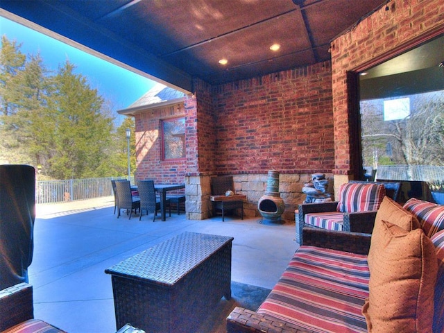 view of patio with fence, outdoor lounge area, and outdoor dining space