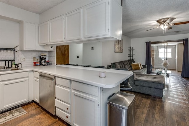 kitchen featuring a peninsula, dark wood-style flooring, open floor plan, and stainless steel dishwasher