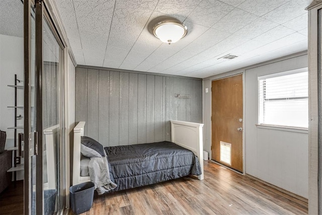 bedroom with visible vents and wood finished floors