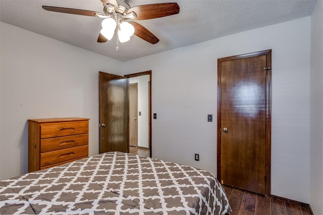 unfurnished bedroom with a textured ceiling, ceiling fan, and wood finished floors