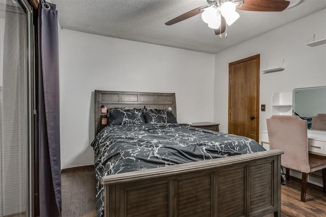 bedroom featuring a textured ceiling, dark wood-type flooring, and a ceiling fan