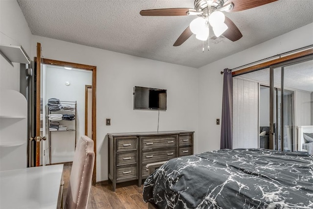 bedroom featuring ceiling fan, a textured ceiling, and wood finished floors