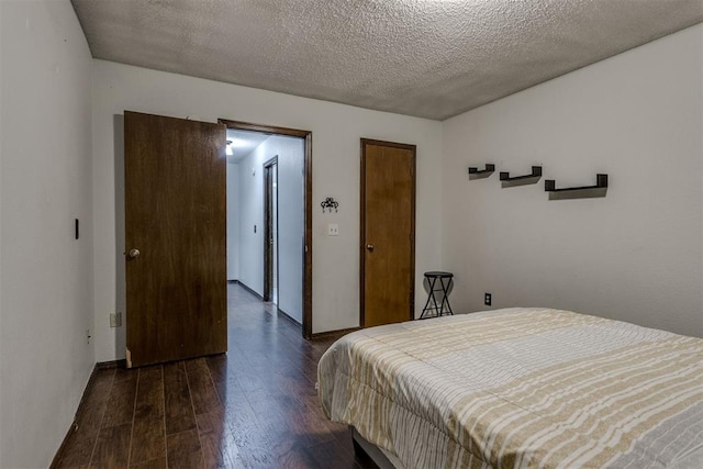 bedroom featuring a textured ceiling and wood finished floors