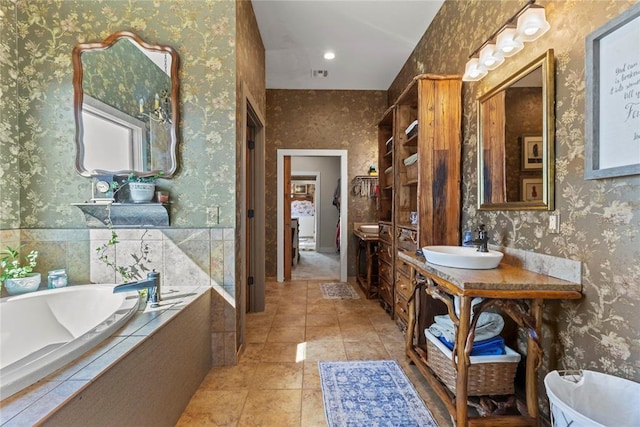 bathroom featuring wallpapered walls, tile patterned floors, and a bath