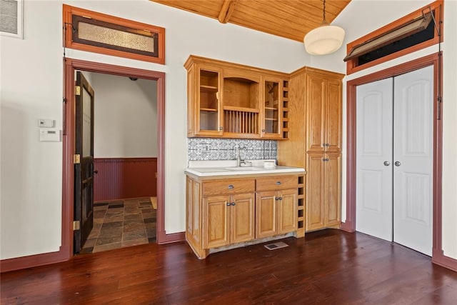 kitchen featuring visible vents, dark wood-type flooring, wainscoting, light countertops, and vaulted ceiling