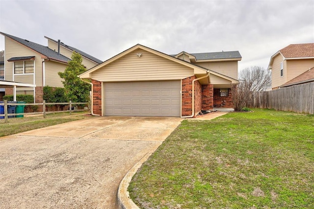 view of front of home with brick siding, concrete driveway, a front yard, and fence