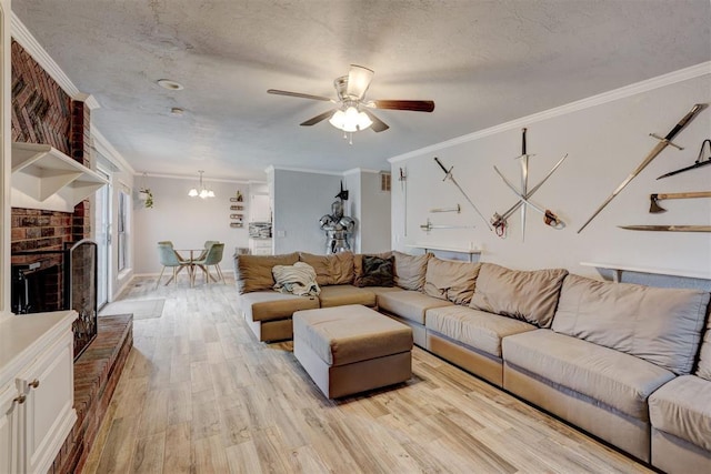 unfurnished living room featuring a fireplace, light wood-style floors, a textured ceiling, crown molding, and ceiling fan with notable chandelier