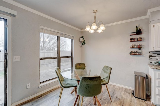 dining space featuring an inviting chandelier, baseboards, light wood finished floors, and ornamental molding