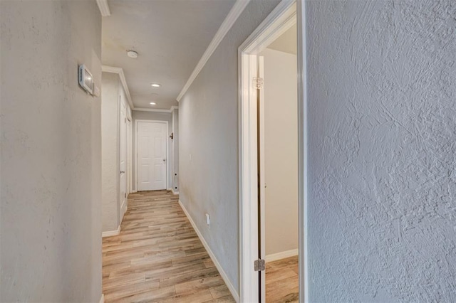 hallway with crown molding, baseboards, light wood-type flooring, recessed lighting, and a textured wall