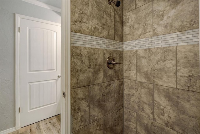 room details with a textured wall and a tile shower