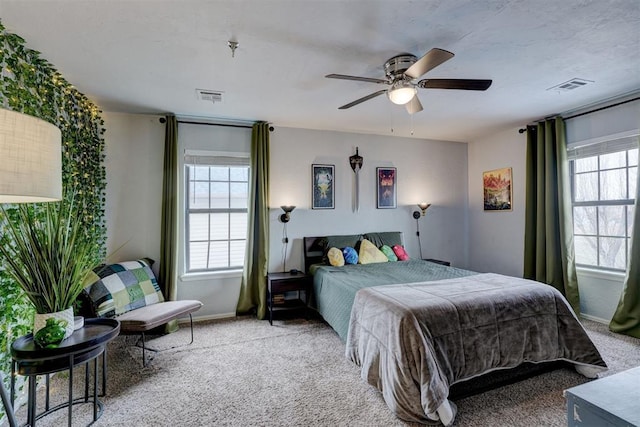 bedroom with visible vents, carpet floors, baseboards, and ceiling fan