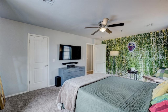 carpeted bedroom with a ceiling fan, visible vents, and baseboards