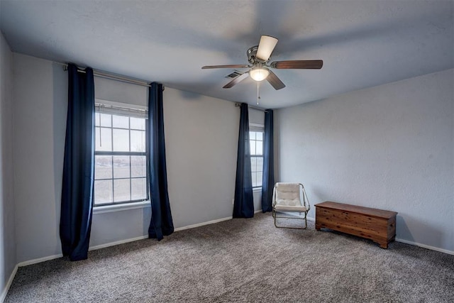 unfurnished room featuring baseboards, visible vents, carpet floors, and ceiling fan