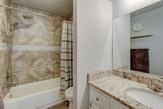 full bath with toilet, a textured ceiling, shower / tub combo, vanity, and a textured wall