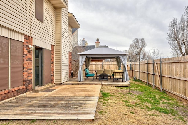 view of yard with a gazebo, a deck, outdoor lounge area, and a fenced backyard